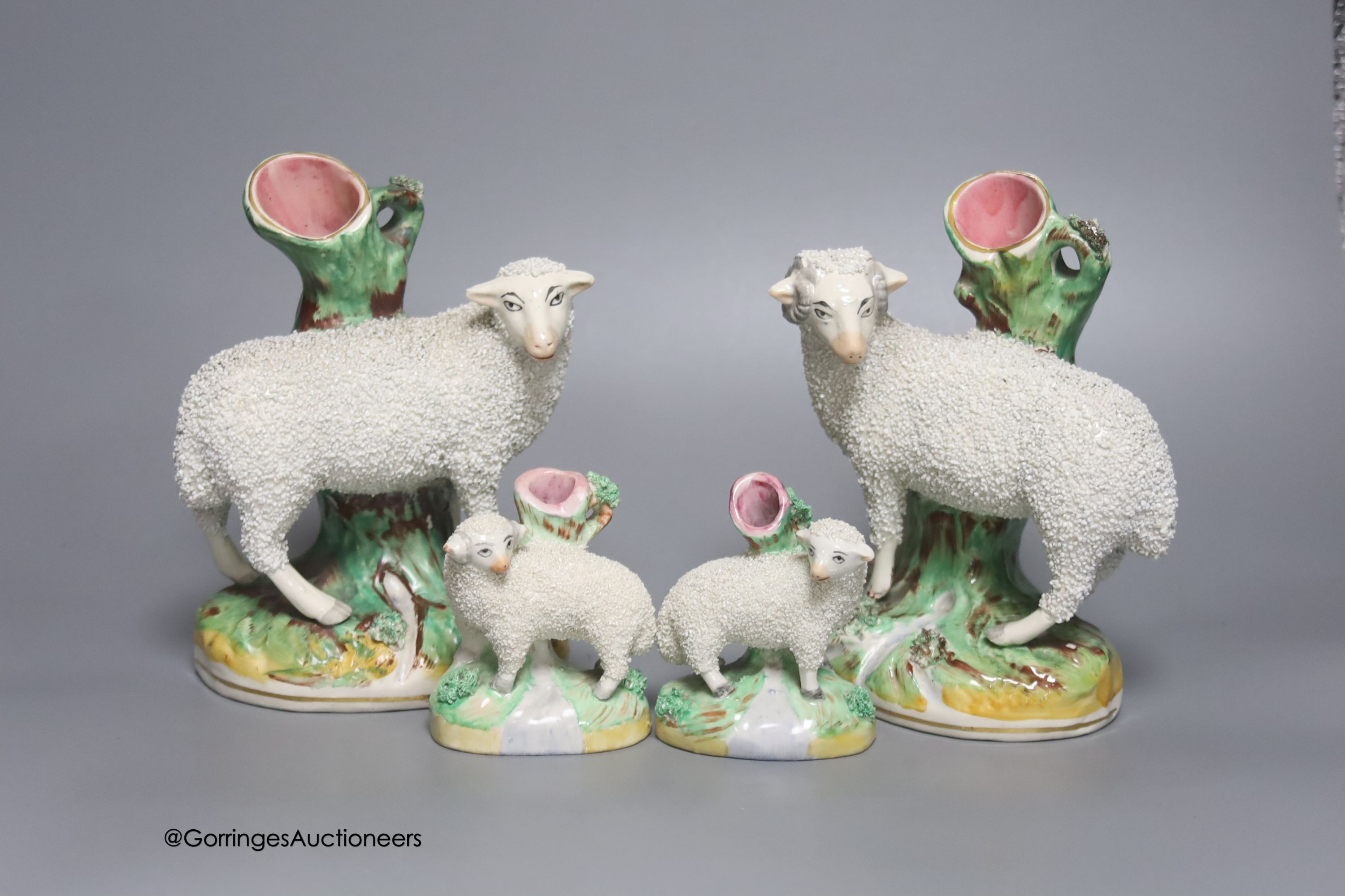A pair of Staffordshire sheep and a smaller similar pair